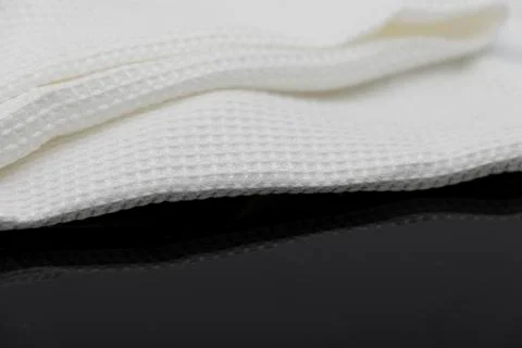 Macro shot texture of folded white towel kitchen fabric with copy space text 写真素材
