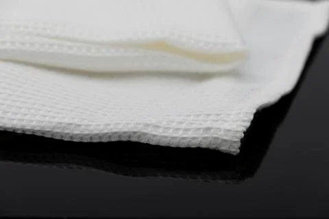Macro shot texture of folded white towel kitchen fabric with copy space text Фото