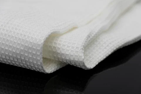 Macro shot texture of folded white towel kitchen fabric with copy space text Stock-Fotos