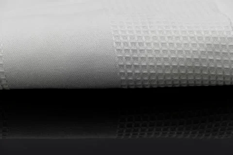 Macro shot texture of folded white towel kitchen fabric with copy space text Stock Photos