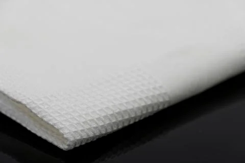 Macro shot texture of folded white towel kitchen fabric with copy space text 스톡 사진