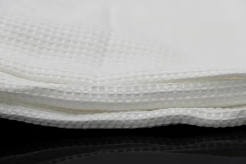 Macro shot texture of folded white towel kitchen fabric with copy space text 스톡 사진