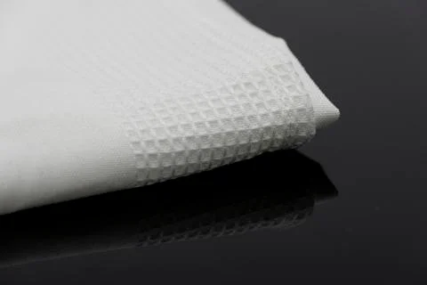 Macro shot texture of folded white towel kitchen fabric with copy space text Stock Photos