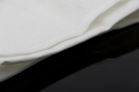 Macro shot texture of folded white towel kitchen fabric with copy space text Stock-Fotos