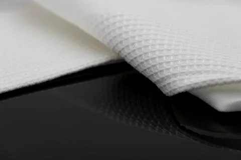 Macro shot texture of folded white towel kitchen fabric with copy space text Stock Photos