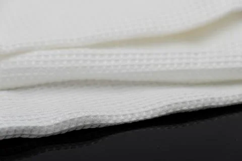 Macro shot texture of folded white towel kitchen fabric with copy space text 库存照片