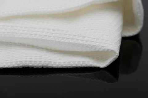 Macro shot texture of folded white towel kitchen fabric with copy space text Stock Photos
