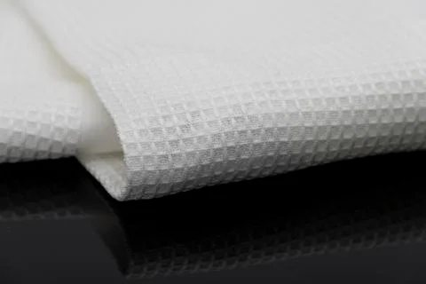 Macro shot texture of folded white towel kitchen fabric with copy space text Stock Photos
