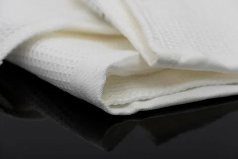 Macro shot texture of folded white towel kitchen fabric with copy space text Stock Photos