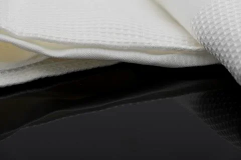 Macro shot texture of folded white towel kitchen fabric with copy space text Stock Photos