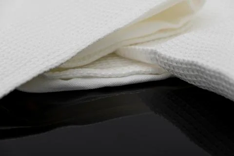 Macro shot texture of folded white towel kitchen fabric with copy space text Stock Photos