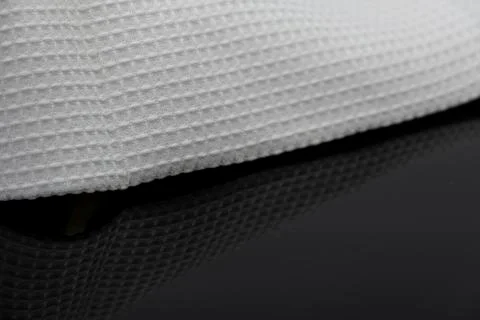 Macro shot texture of folded white towel kitchen fabric with copy space text Stock Photos