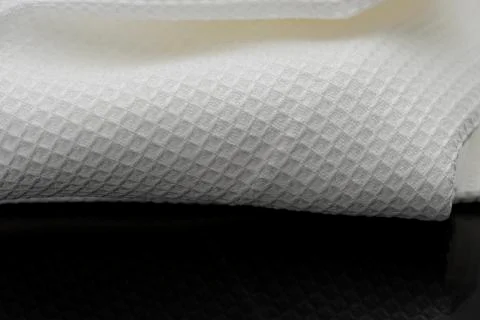 Macro shot texture of folded white towel kitchen fabric with copy space text Stock Photos
