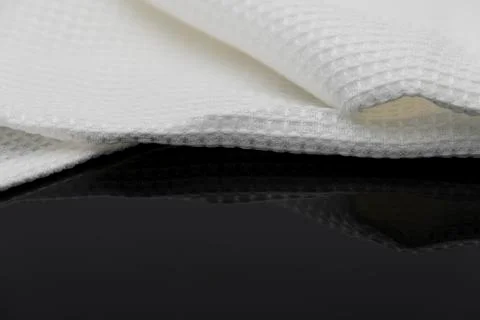 Macro shot texture of folded white towel kitchen fabric with copy space text Stock Photos
