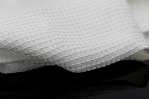 Macro shot texture of folded white towel kitchen fabric with copy space text Stock Photos