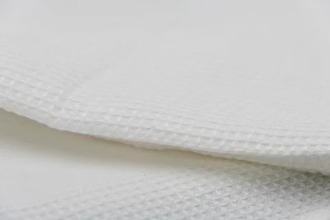 Macro shot texture of folded white towel kitchen fabric for background design Stock-Fotos