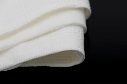 Macro shot texture of folded white towel kitchen fabric with copy space text Stock Photos