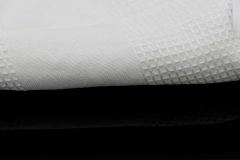 Macro shot texture of folded white towel kitchen fabric with copy space text Stock Photos
