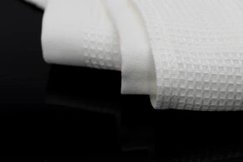 Macro shot texture of folded white towel kitchen fabric with copy space text Stock Photos