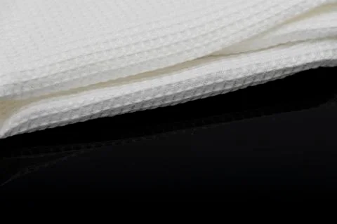 Macro shot texture of folded white towel kitchen fabric with copy space text Stock Photos
