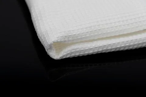 Macro shot texture of folded white towel kitchen fabric with copy space text 스톡 사진