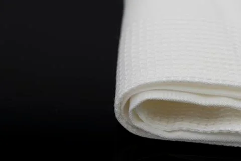 Macro shot texture of folded white towel kitchen fabric with copy space text Stock Photos