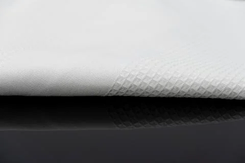 Macro shot texture of folded white towel kitchen fabric with copy space text Stock Photos