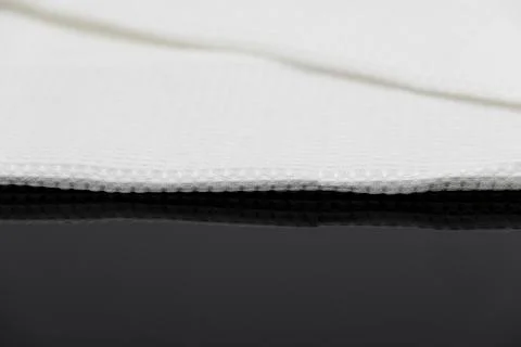 Macro shot texture of folded white towel kitchen fabric with copy space text Stock Photos