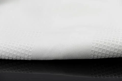 Macro shot texture of folded white towel kitchen fabric with copy space text Stock Photos