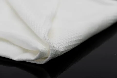 Macro shot texture of folded white towel kitchen fabric with copy space text Stock Photos