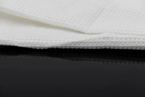 Macro shot texture of folded white towel kitchen fabric with copy space text Stock Photos