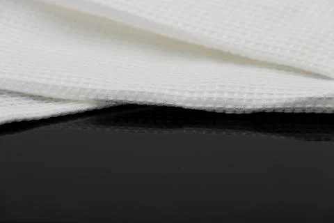 Macro shot texture of folded white towel kitchen fabric with copy space text Stock Photos