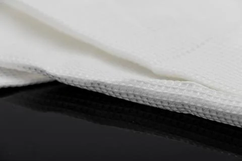 Macro shot texture of folded white towel kitchen fabric with copy space text Stock Photos