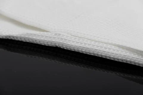 Macro shot texture of folded white towel kitchen fabric with copy space text Stock Photos