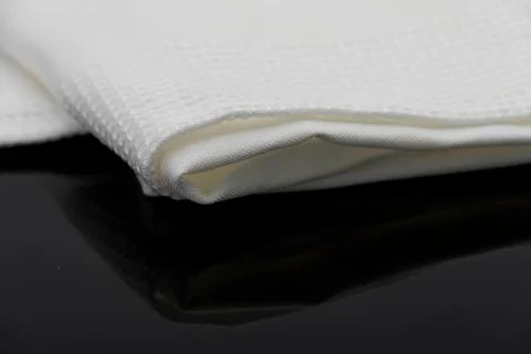 Macro shot texture of folded white towel kitchen fabric with copy space text Stock Photos
