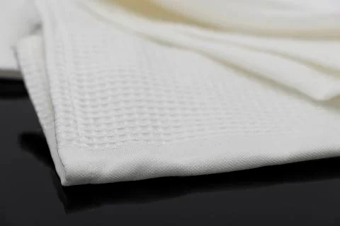 Macro shot texture pattern of folded white towel kitchen fabric Stockfoto's