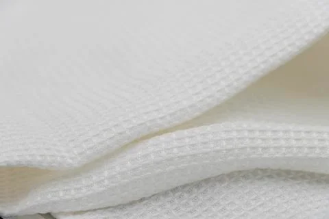 Macro shot texture pattern of folded white towel kitchen fabric 写真素材