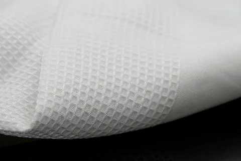 Macro shot texture pattern of folded white towel kitchen fabric Фото