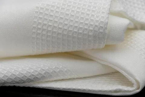 Macro shot texture pattern of folded white towel kitchen fabric Stock Photos