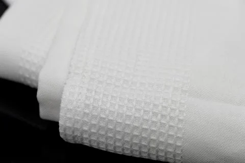 Macro shot texture pattern of folded white towel kitchen fabric Stock Photos