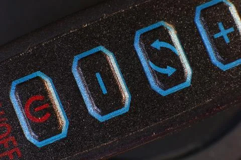 Macro shot of textured control panel with power, volume and settings Stock Photos