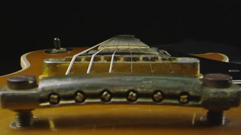 Macro shot through an electric guitar that is laying down Stock Footage 130544015