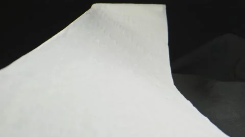 Macro shot through moving toilet paper sheets Stock Footage 130544087