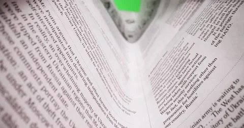 Macro shot through newspaper article on war in Ukraine in front of green screen Stock Footage 179548718