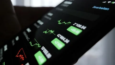Macro shot of thumb, hand scrolling and checking various stock prices. Video stock 149988982
