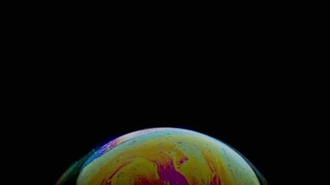 Macro shot of top of soap bubble with mesmerizing blue-yellow colored surface Stock Footage 146527878
