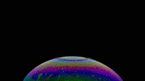 Macro shot of the top of soap bubble with an iridescent multicolored surface Stock Footage 146528757