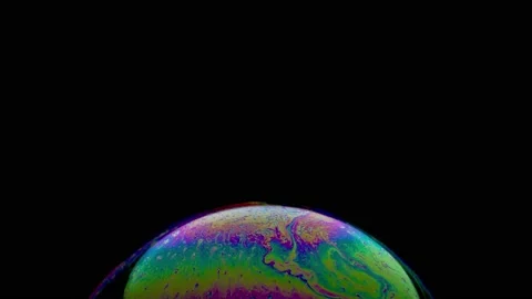Macro shot of top of soap bubble with magical blue yellow green colored surface Stock Footage 146529879