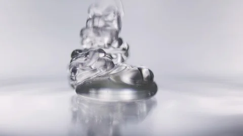 Macro shot of transparent gel accumulating on a glas plade Stock Footage 100592471