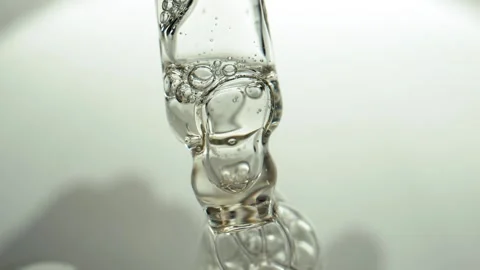 Macro shot of transparent pipette from which liquid is squeezed out with bubbles Stock Footage 293737840